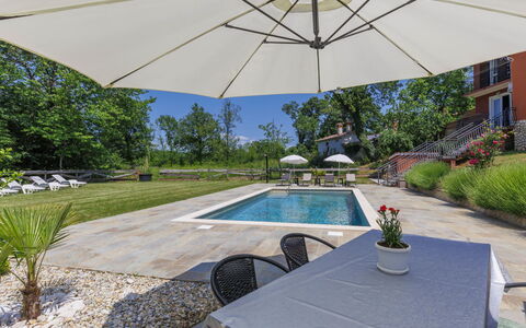 Korina: Plant, Property, Water, Furniture, Shade, Umbrella, Couch, Outdoor Furniture, Chair, Table