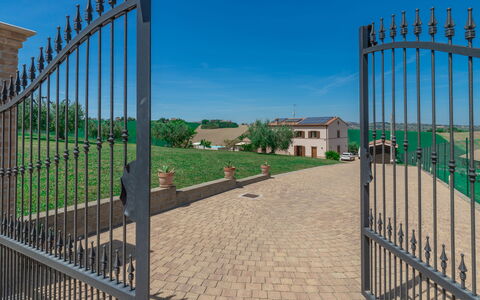 Villa Clair: Sky, Property, Plant, Fence, Road Surface, Composite Material, Urban Design, Grass, Brick, Facade