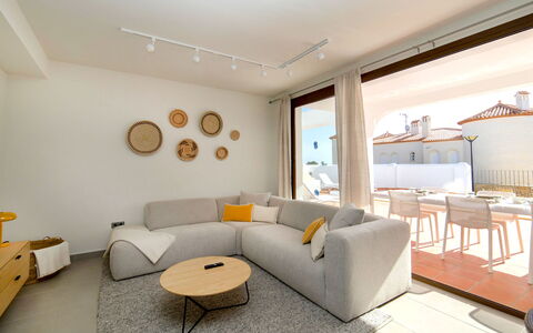 Mirador de les Bassetes: Furniture, Property, Couch, Picture Frame, Comfort, Building, Table, Living Room, Orange, Lighting