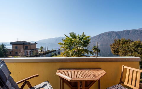 Borgo San Giulio: Sky, Furniture, Building, Property, Mountain, Azure, Tree, Outdoor Furniture, Shade, House