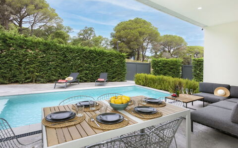 Alyssa: Plant, Furniture, Table, Building, Water, Outdoor Furniture, Sky, Chair, Tree, Cloud