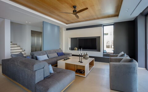 Nereid Luxury Villa: Couch, Furniture, Picture Frame, Property, Table, Comfort, Living Room, Lighting, Interior Design, Ceiling Fan