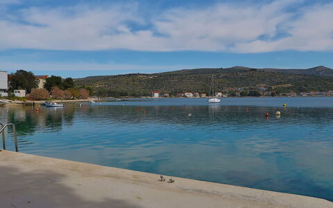 Kira: Water, Sky, Plant, Building, Azure, Natural Landscape, Tree, Body Of Water, Beach, Terrain
