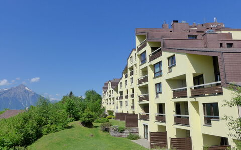 Enzian 720: Plant, Sky, Building, Window, Land Lot, Urban Design, Tree, Mountain, Grass, Condominium