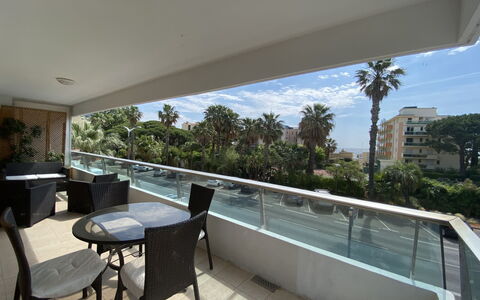 Les Palmiers: Furniture, Property, Table, Plant, Sky, Shade, Chair, Architecture, Cloud, Tree