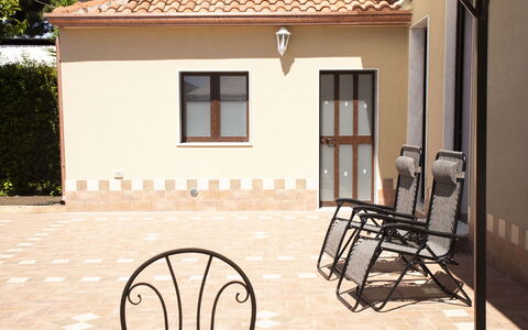 Villa Saponara: Furniture, Floor, Flooring, Door, Porch, Outdoor Furniture, Chair, Wood Stain, Shade, Courtyard