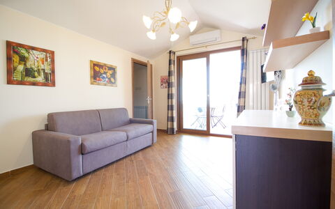 Etna Suites: Furniture, Property, Couch, Picture Frame, Cabinetry, Wood, Lighting, Interior Design, Comfort, Living Room