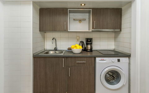 Cosy Lloret: Washing Machine, Major Appliance, Kitchen, Countertop, Plumbing Fixture, Interior Design, Cabinetry, Kitchen Appliance, Flooring, Sink