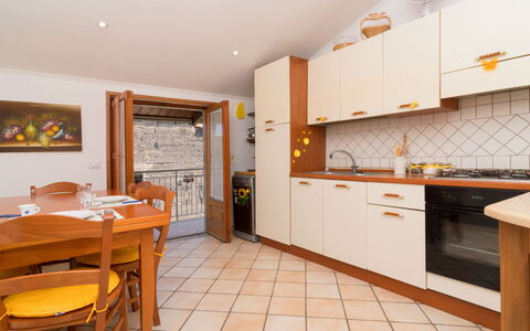 Mansardina sui Due Golfi: Cabinetry, Furniture, Countertop, Chair, Orange, Kitchen, Wood, Table, Architecture, Interior Design
