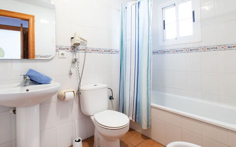 Ladera del Mar: Plumbing Fixture, Mirror, Property, Sink, Toilet Seat, Toilet, Tap, Blue, Purple, Bathroom