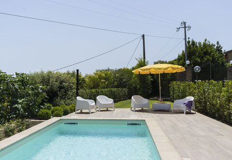 Villa Bougainvillea: Water, Plant, Property, Sky, Swimming Pool, Shade, Umbrella, Outdoor Furniture, Building, Grass