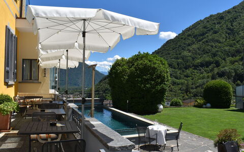 Intragna 55: Sky, Plant, Furniture, Building, Shade, Umbrella, Swimming Pool, Outdoor Furniture, Cloud, Window