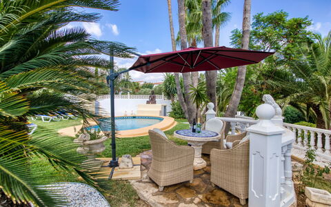 Villa Jolanda: Plant, Sky, Property, Water, Tree, Azure, Swimming Pool, Outdoor Furniture, Shade, Arecales
