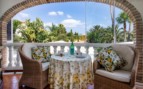 Villa Jolanda: Table, Sky, Plant, Furniture, Property, Cloud, Decoration, Azure, Chair, Tree