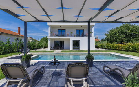 Villa Essea: Plant, Property, Water, Swimming Pool, Building, Shade, Window, Interior Design, Outdoor Furniture, Chair
