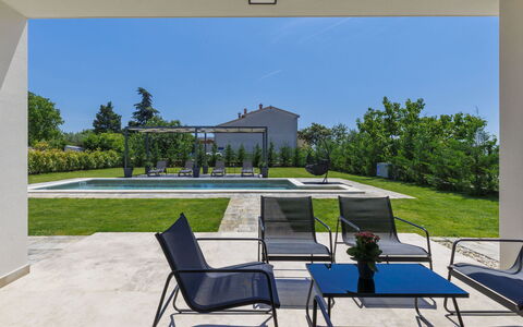 Villa Essea: Property, Daytime, Sky, Furniture, Plant, Nature, Rectangle, Shade, Building, Outdoor Furniture