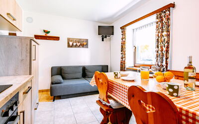Canazei 440: Furniture, Table, Property, Picture Frame, Couch, Orange, Chair, Interior Design, Window, Wood