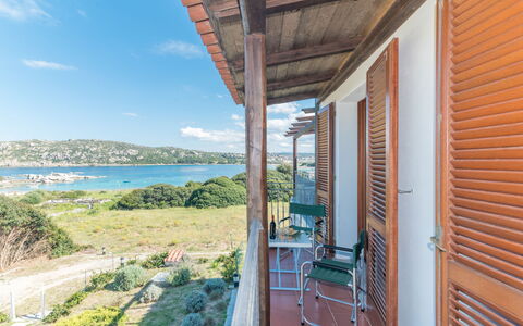 Capo Testa: Sky, Plant, Water, Cloud, Building, Porch, Wood, Shade, Cottage, Residential Area
