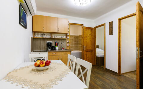 Liget: Furniture, Property, Cabinetry, Table, Countertop, Interior Design, Wood, Lighting, Orange, Flooring