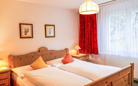 Chalet Wyssefluh: Furniture, Bed, Interior Design, Bedroom, Bed Sheet, Wood, Bedding, Ceiling, Room, Flooring