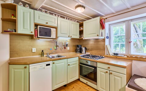 Sunny Slope & Sauna: Kitchen, Wood, Interior Design, Cabinetry, Kitchen Appliance, Countertop, Major Appliance, Flooring, Floor, Drawer