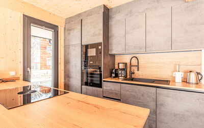 #1A mit Sauna & Pool 180.3: Cabinetry, Countertop, Furniture, Table, Wood, Kitchen, Interior Design, Kitchen Stove, Home Appliance, Wood Stain