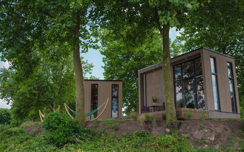 Tiny River House: Water, Building, Sky, Cloud, Daytime, Property, Plant, Light, Nature, Green
