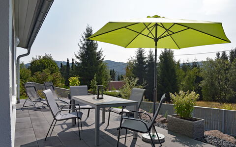 Anna: Plant, Table, Furniture, Property, Umbrella, Building, Sky, Tree, Chair, Shade