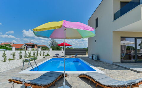 Sunset: Sky, Building, Property, Daytime, Water, Swimming Pool, Umbrella, Azure, Shade, Sunlounger