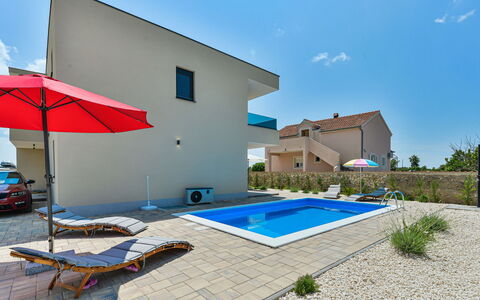 Sunset: Sky, Property, Building, Plant, Cloud, Shade, Swimming Pool, Outdoor Furniture, House, Window
