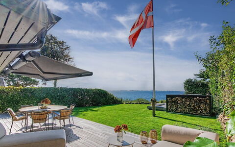 Daike - 25M from the Sea: Sea, Lawn, Garden, Ocean, Outdoor Furniture, Coast, Landscaping, Shade, Tropics, Umbrella