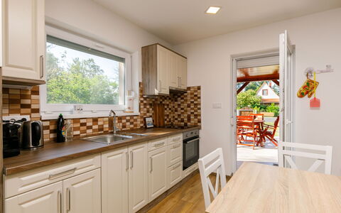 Honey: Cabinetry, Furniture, Countertop, Window, Wood, Flooring, Kitchen, Floor, Wood Stain, Drawer