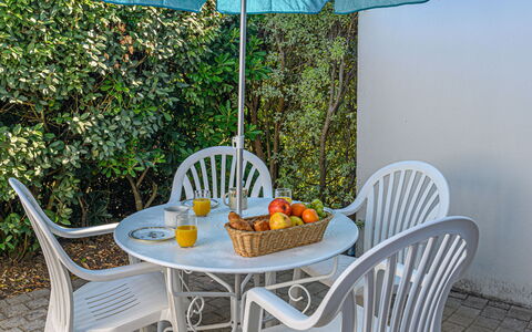 Les Eiders: Table, Furniture, Plant, Property, Tableware, Chair, Outdoor Table, Umbrella, Outdoor Furniture, Shade