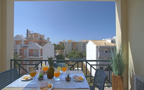 Sunny Beach Retreat: Sky, Plant, Furniture, Plant Community, Table, Natural Landscape, Chair, Land Lot, Outdoor Furniture, Tree