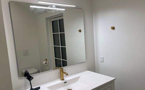 Skrollan - 100M from the Sea: Mirror, Interior Design, Lighting, Plumbing Fixture, Bathroom Sink, Light Fixture, Ceiling, Plumbing, Tap, Bathroom