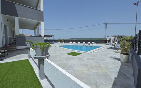 Franka: Sky, Building, Street Light, Plant, Shade, Architecture, Urban Design, Swimming Pool, Outdoor Furniture, Roof