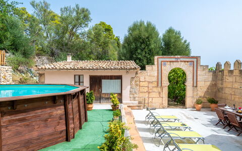 Sa Bisbal: Plant, Sky, Property, Furniture, Table, Shade, Chair, Building, Tree, Architecture