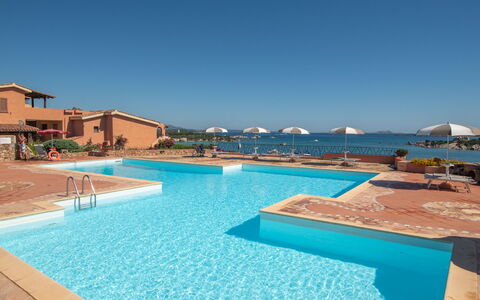 Golfo di Marinella 320: Water, Sky, Property, Swimming Pool, Azure, Building, Outdoor Furniture, Shade, Seaside Resort, Leisure