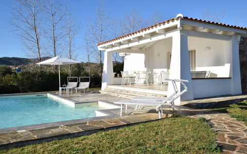 Villa Helios - Budoni, Sardegna: Water, Plant, Sky, Shade, Swimming Pool, Outdoor Furniture, Residential Area, Composite Material, Tree, Grass