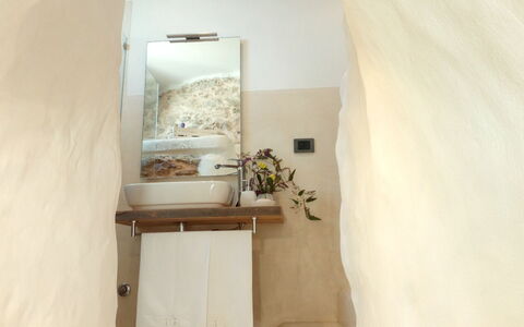 Villa Trullo - Torricella, Puglia: Flower, Building, Plant, Bathroom, Wood, Floor, Houseplant, House, Plaster, Flooring