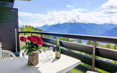 Crans-Montana 371: Sky, Cloud, Table, Plant, Furniture, Building, Property, Flowerpot, Flower, Chair