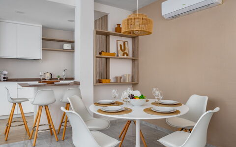Ático Los Pelicanos: Table, Furniture, Property, White, Chair, Shelf, Lighting, Wood, Orange, Interior Design