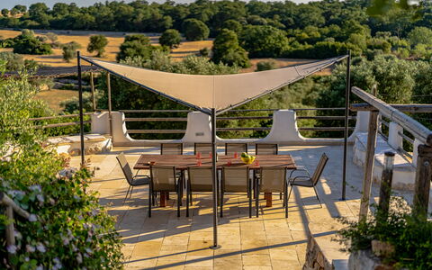 Trulli Di Grieco: Table, Plant, Furniture, Plant Community, Chair, Building, Tree, Outdoor Furniture, Shade, Outdoor Table