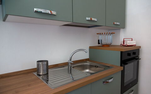 Villa Trivigno: Kitchen, Countertop, Cabinetry, Wood, Kitchen Sink, Interior Design, Flooring, Kitchen Appliance, Plumbing Fixture, Furniture
