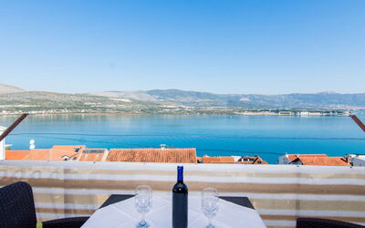 Trogir 183: Sky, Water, Table, Property, Furniture, Blue, Azure, Chair, Mountain, Building
