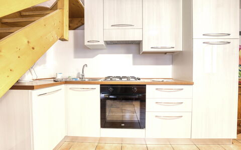 Incanto Walser Apartments Ronco: Cabinetry, Countertop, Furniture, Kitchen, Kitchen Stove, Wood, Drawer, Building, Interior Design, Flooring