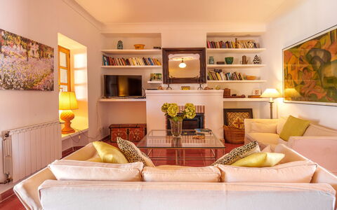 Gran Llombards: Property, Furniture, Couch, Lighting, Orange, Table, Living Room, Shelf, Interior Design, Shelving