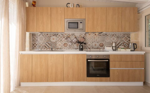 Terra Mater: Kitchen, Countertop, Major Appliance, Kitchen Appliance, Wood, Flooring, Cabinetry, Interior Design, Floor, Brown