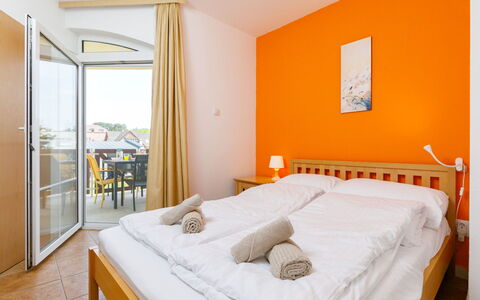 Balatonlelle 101: Furniture, Property, Comfort, Building, Bed, Bed Frame, Textile, Wood, Orange, Interior Design