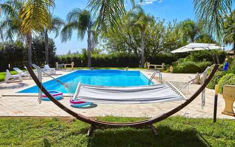 Villa Selinunte: Plant, Sky, Water, Azure, Tree, Shade, Swimming Pool, Outdoor Furniture, Arecales, Cloud